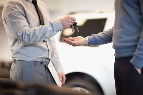 Dealership giving keys to new car owner