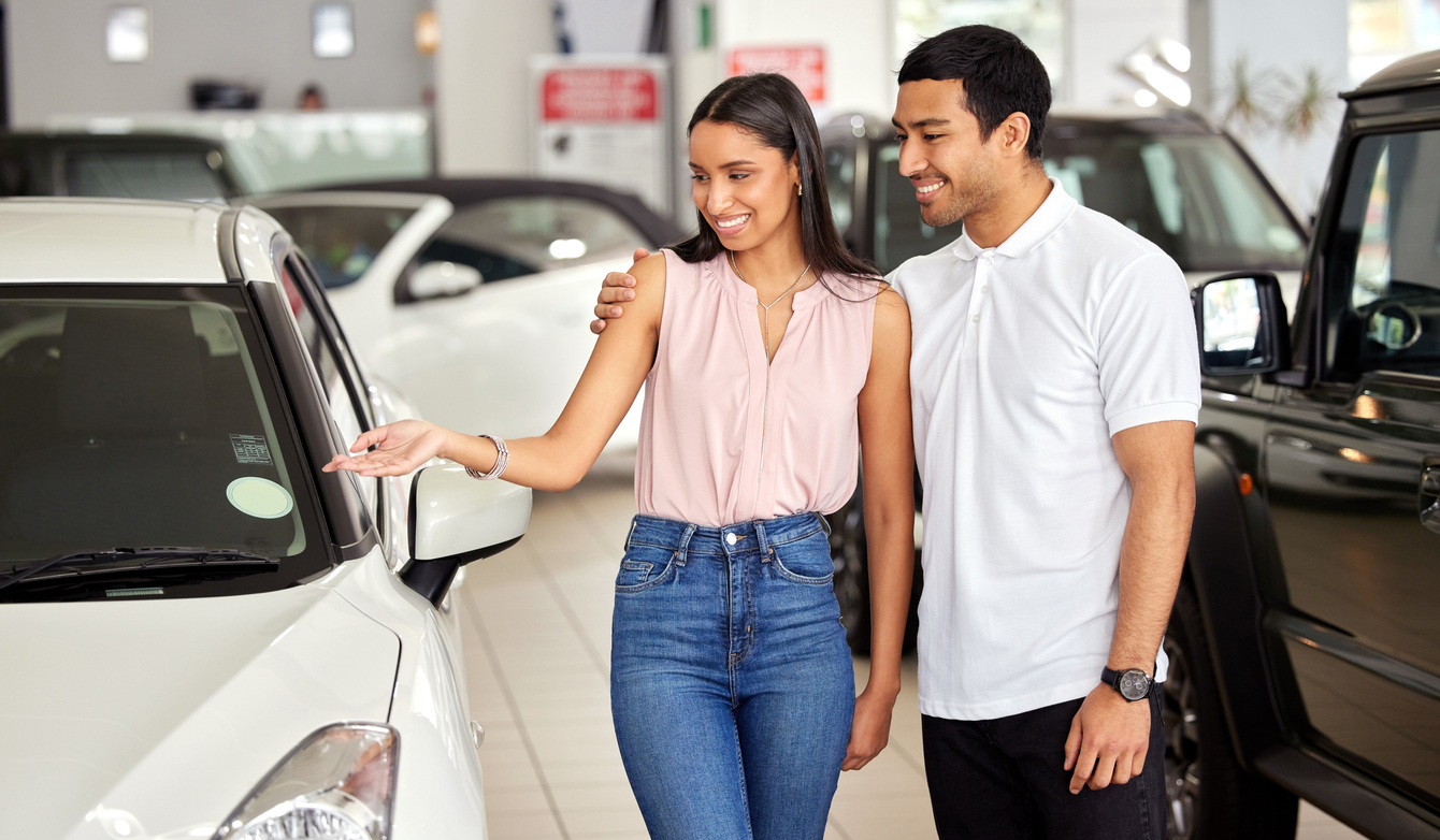 A young attractive couple shopping for the Best Cars for City Commutes